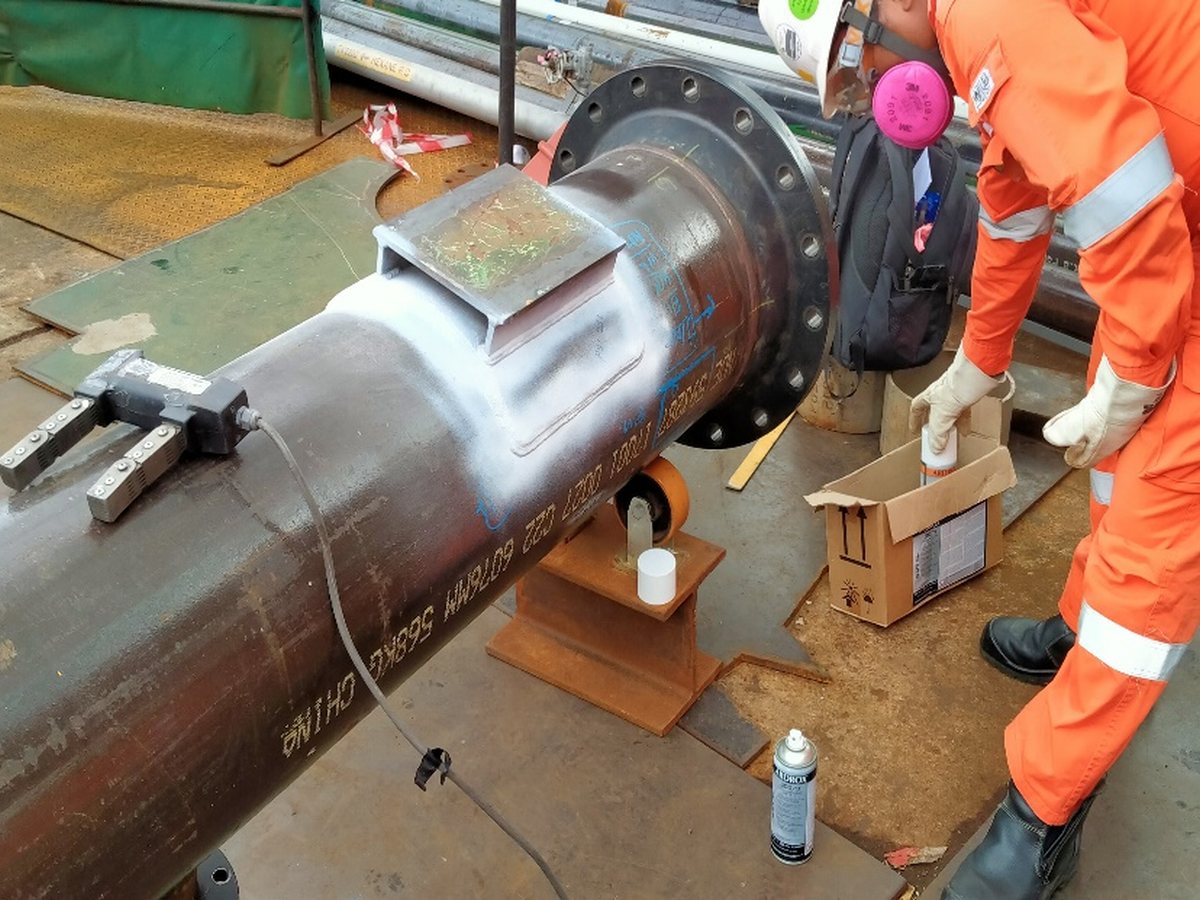 Dye-penetrant weld inspection on a flanged pipe spool
